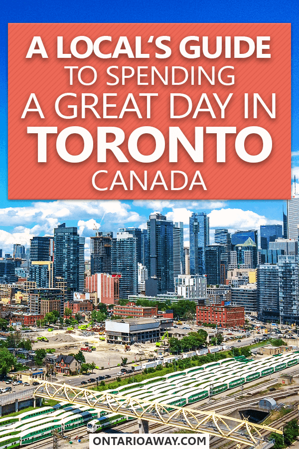 photo of tall buildings with train tracks in front with text overlay How to spend one day in Toronto, Canada