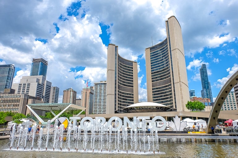tall curved city hall buildings with fountain at base in toronto canada