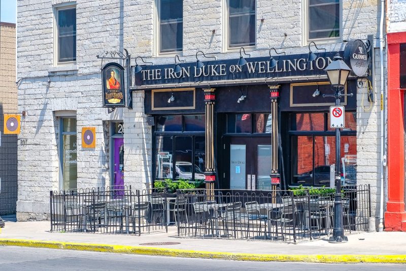 exterior of pub with patio chairs on sidewalk in kingston ontario