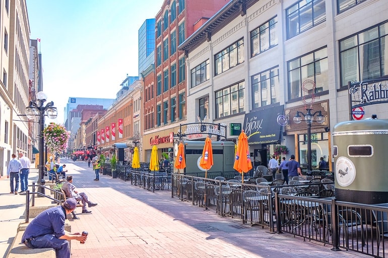 long pedestrian street with patios and people sitting