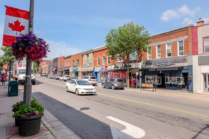 red brick shops with car in street in downtown huntsville ontario