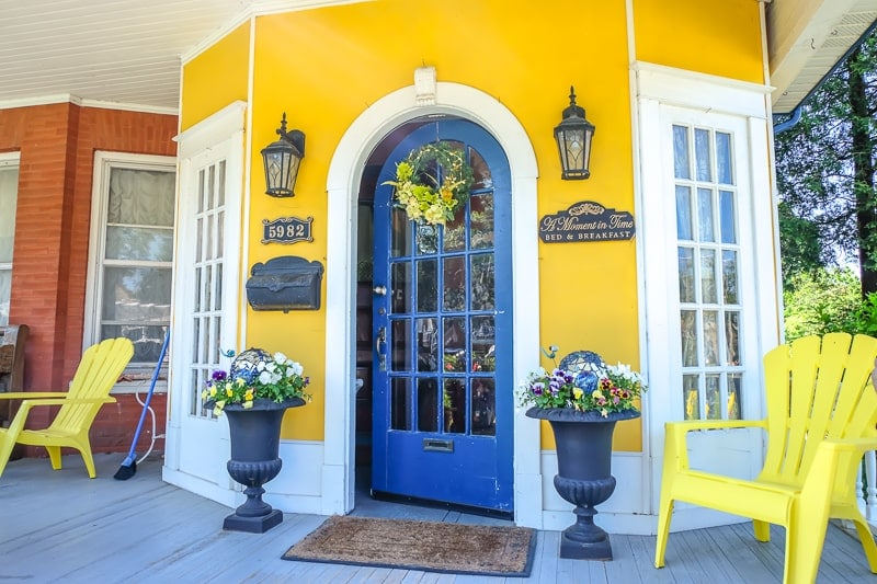 blue door entrance on yellow exterior wall for bed and breakfast