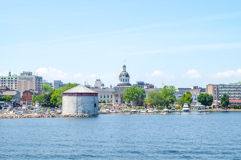 blue water with historic kingston ontario in background