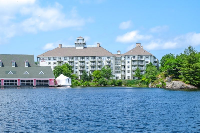 large hotel by the waterfront and blue lake in gravenhurst muskoka