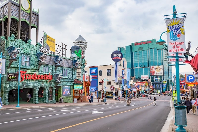 downtown street with hotels restaurants and bright attractions beside
