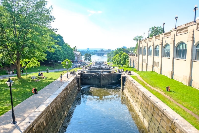 historic rideau canal locks in ottawa beside building and green grass