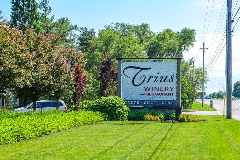 large sign by roadway for trius winery in niagara on the lake with green lawn in front