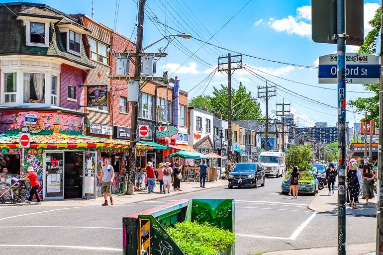 neighbourhood street with people and colourful shops in kensington market