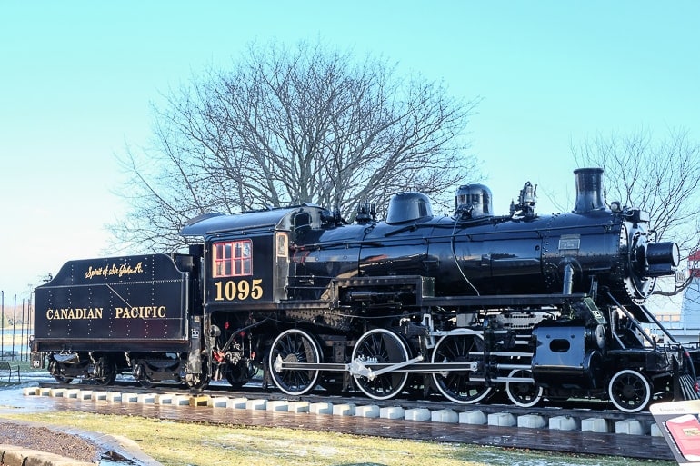 old black steam engine with blue sky behind