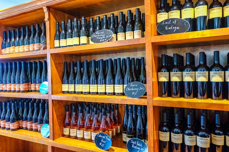 wine bottles on the wooden shelves at ravine winery.