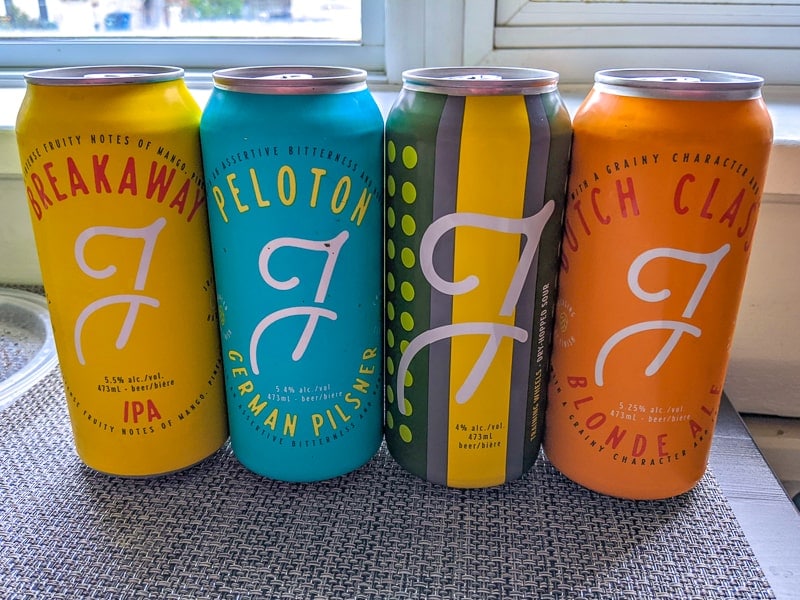 colourful beer cans on table from fixed gear brewing company.