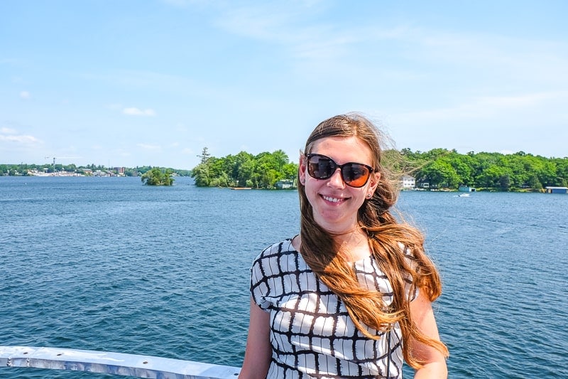 woman with sunglasses posing for photo on 1000 islands cruise.