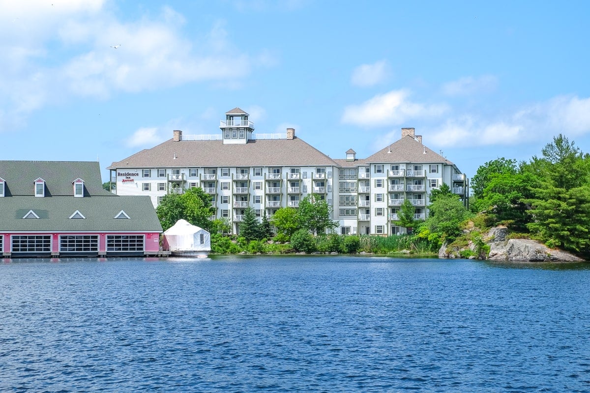 large hotel by the waterfront and blue lake in gravenhurst muskoka.