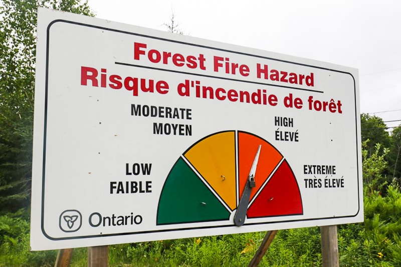 fire hazard board in forest with colourful scale 