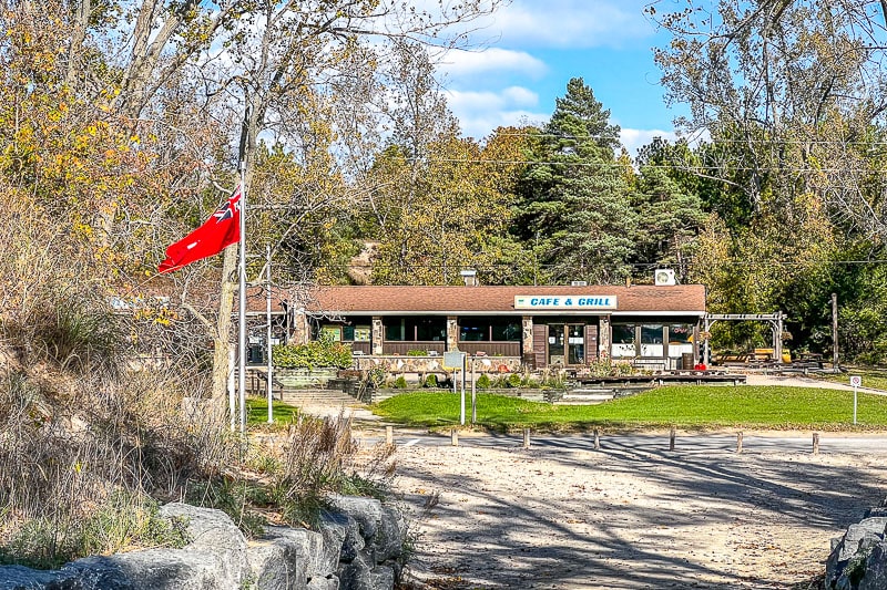 restaurant building with red flag in front at sandbanks provincial park