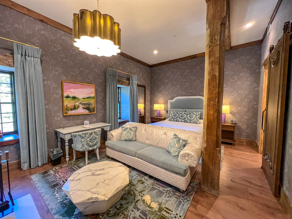 upscale room interior with big beg couch and wooden beam at elora inn hotel and spa.